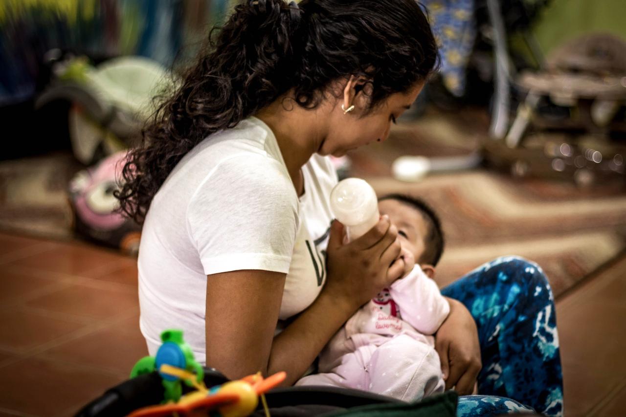 Woman feeding a baby