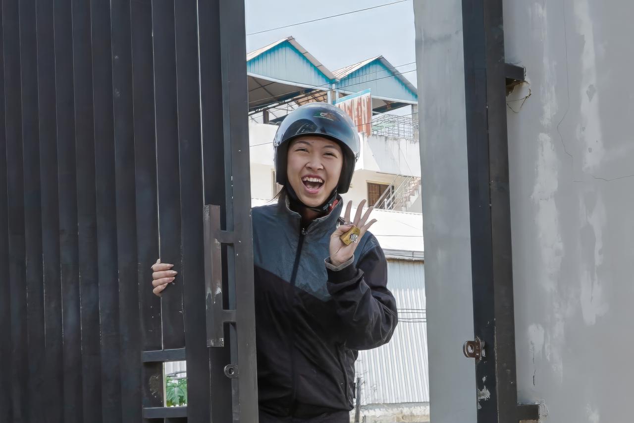 Girl waving at gate.