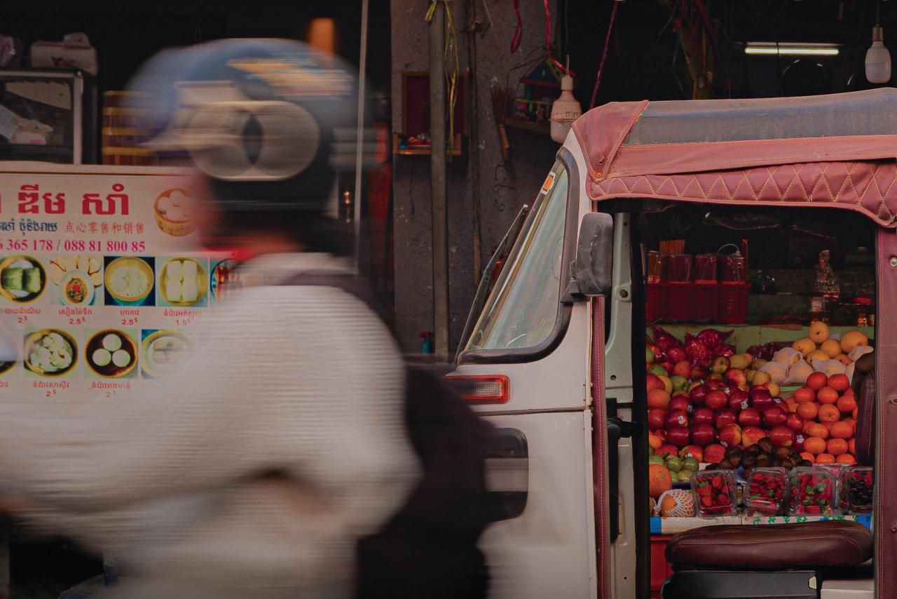 Girl on moto in busy market.