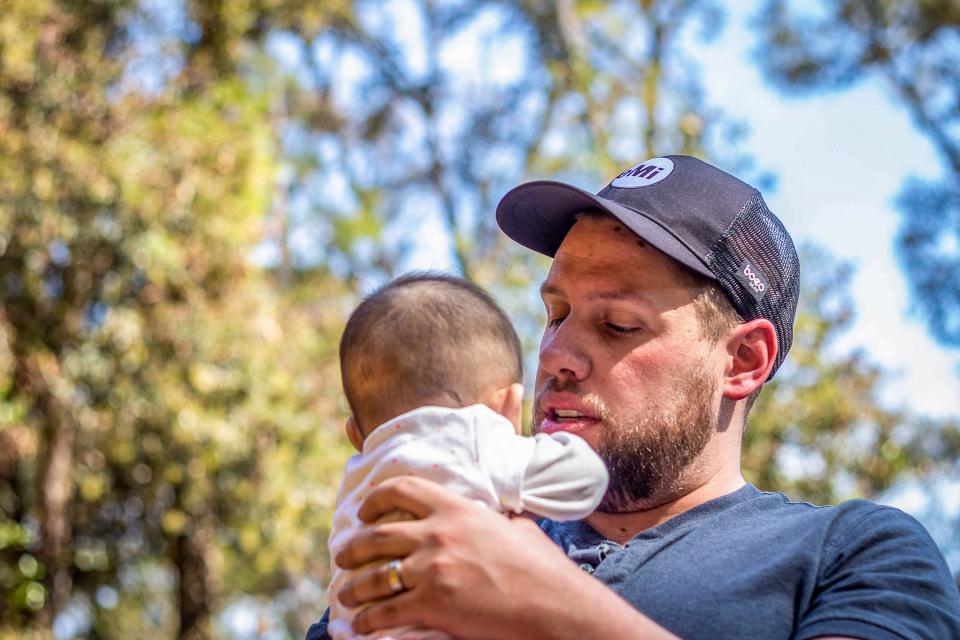 Braden holding a baby