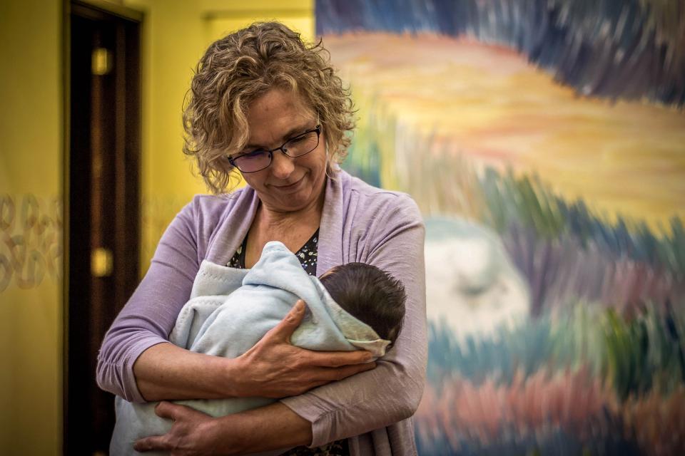 Sandra holding a baby