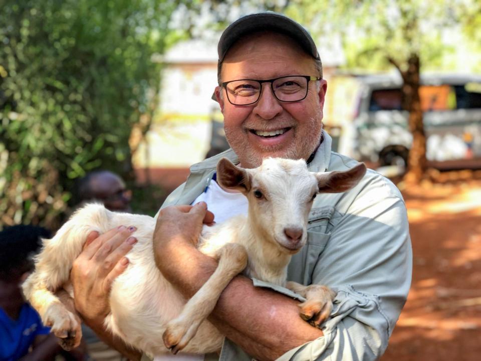 Rex holding a goat