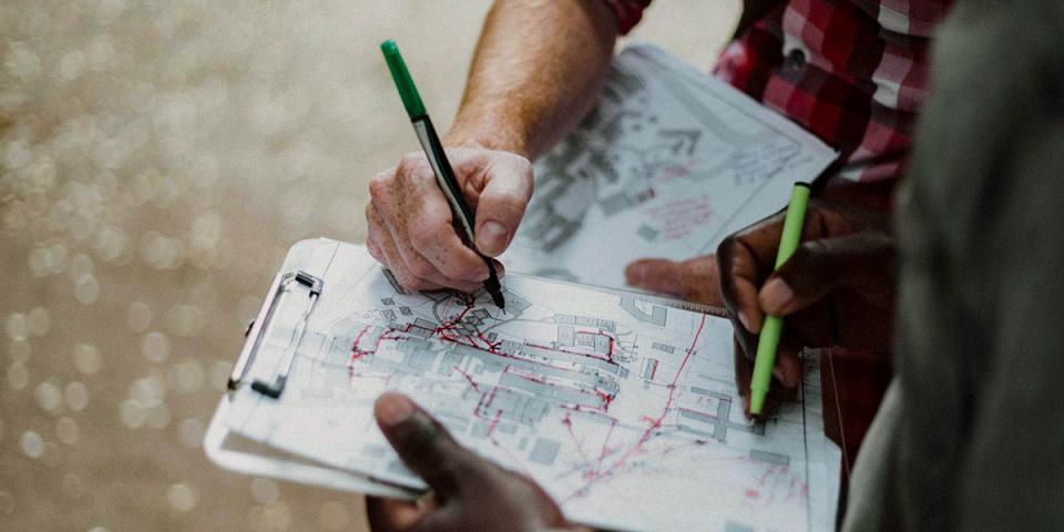 Two people looking over plans