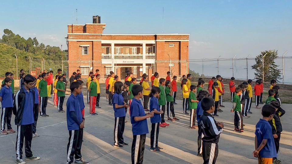 Children assembled in front of new building