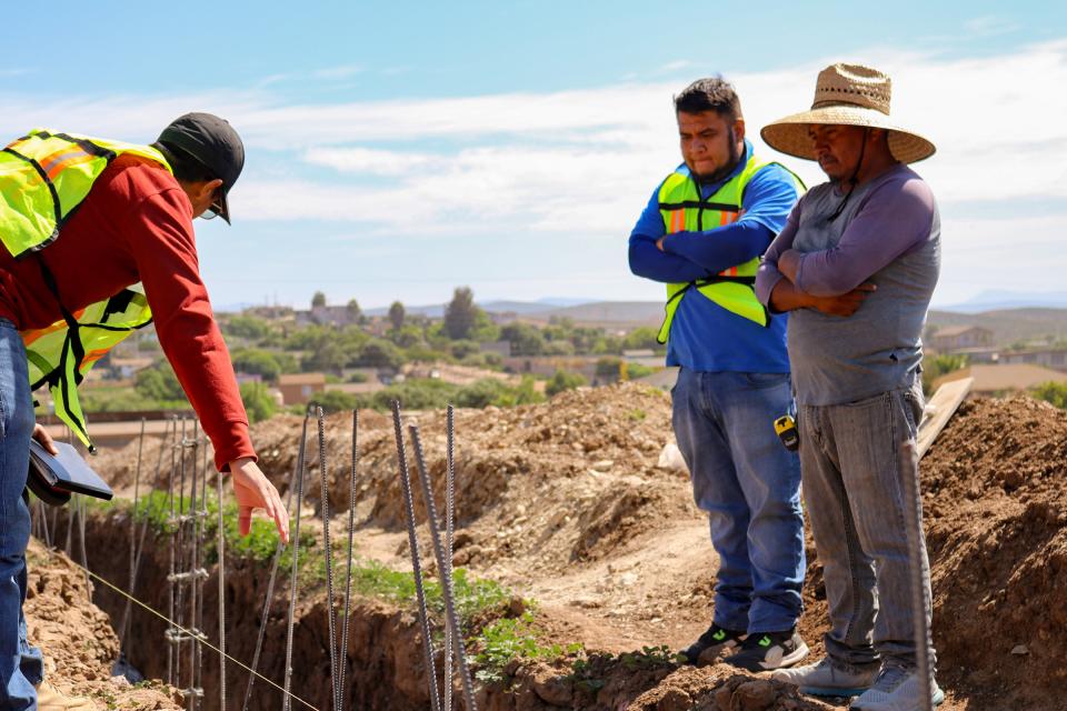 Workers examining the foundation trench