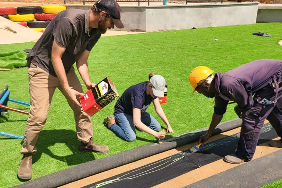 Laying down turf on the playground