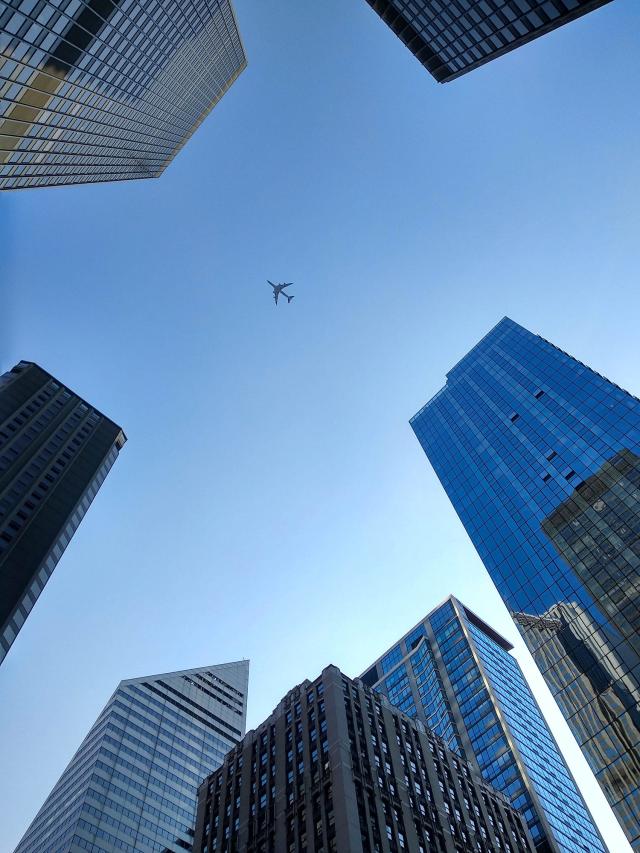 Airplane flying over buildings